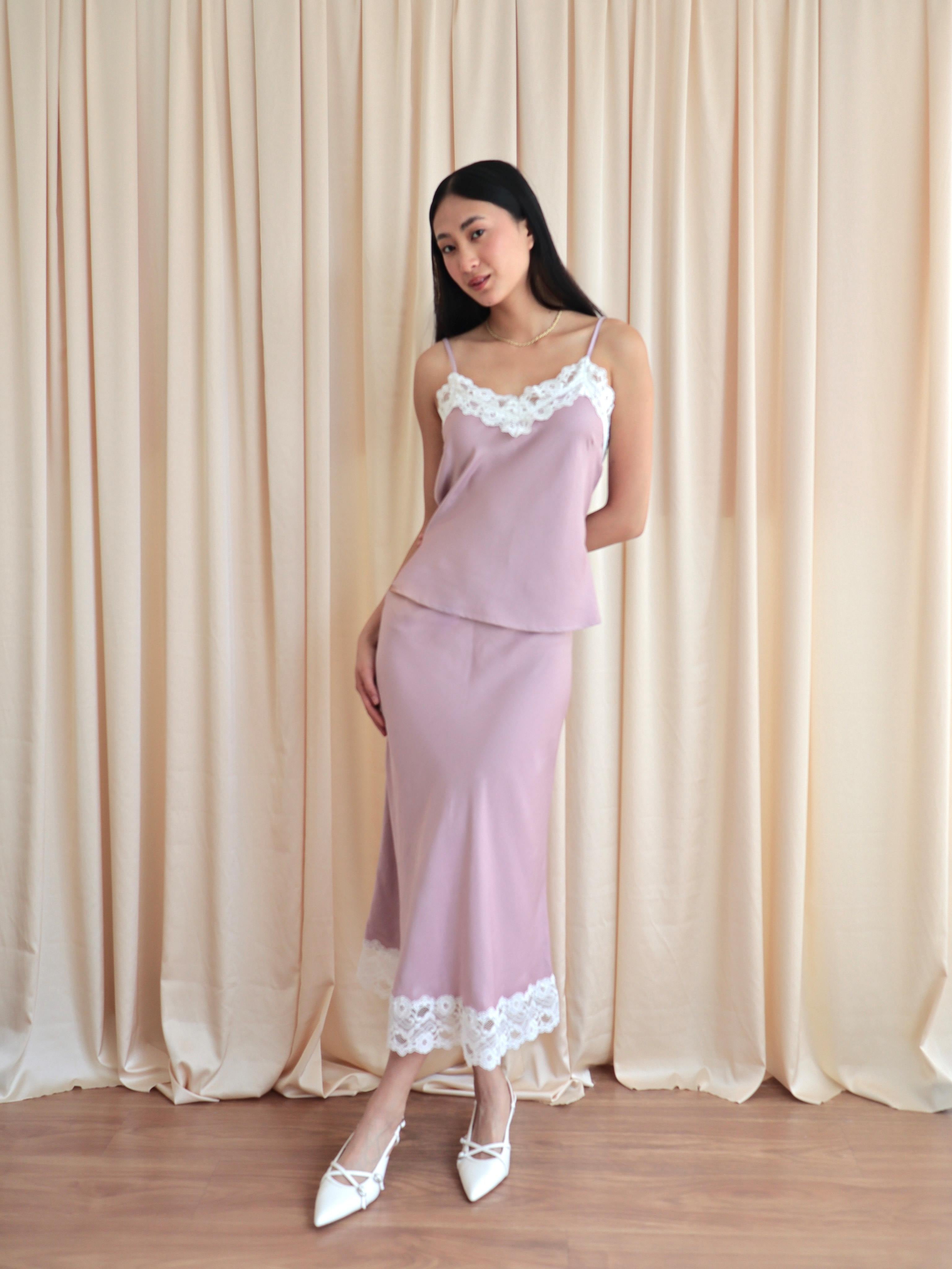 Mujer usando set de seda estilo lencero color rosa.