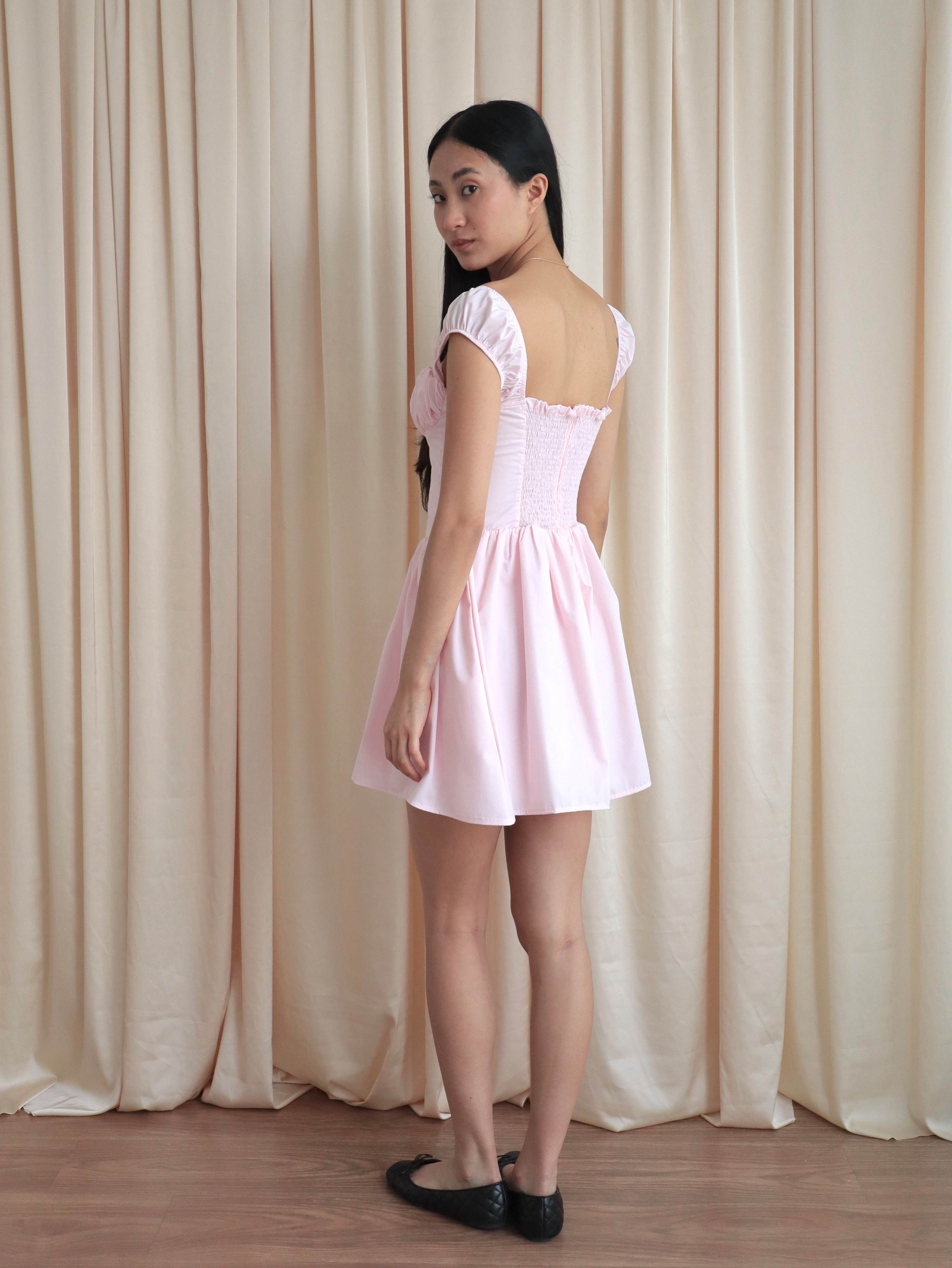 mujer usando vestido rosado hecho de popelina de algodón forrado para verano, con elasticado en espalda